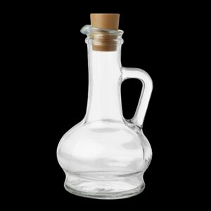 Empty glass bottle with cork stopper, isolated on black background