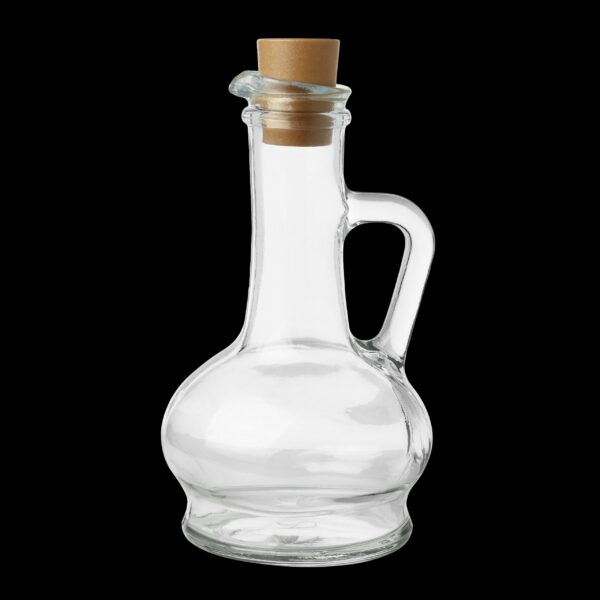 Empty glass bottle with cork stopper, isolated on black background